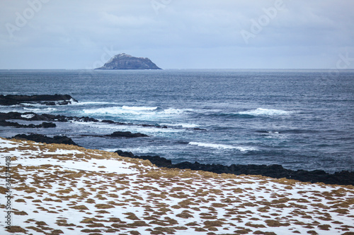 Lonely remote island in the Atlantic ocean in the North of Iceland. photo