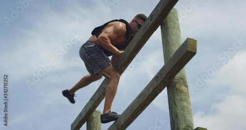 Athletic man performing obstacle course training