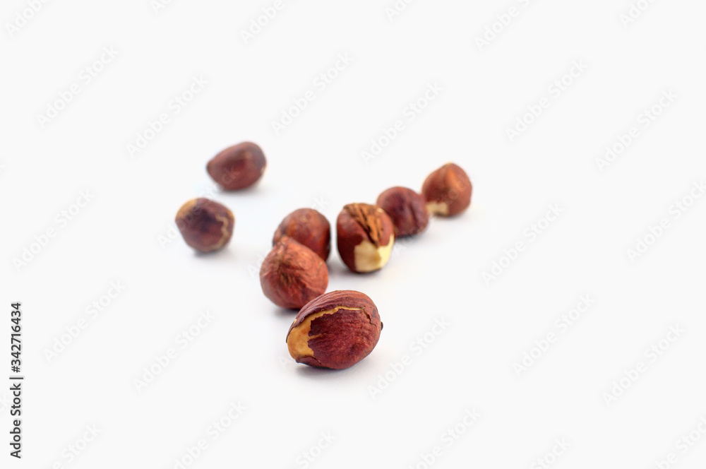 A few hazelnuts isolated on a white background. Well suited for baking or in healthy muesli. A few hazelnuts isolated on a white background. Well suited for baking or in healthy muesli.