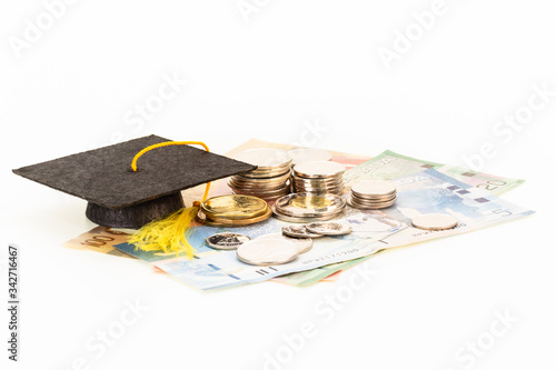 Education costs concept with coins and mortar board