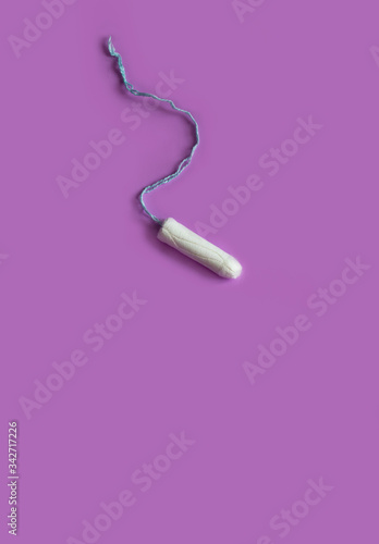 tampon on a purple background, close-up, top view