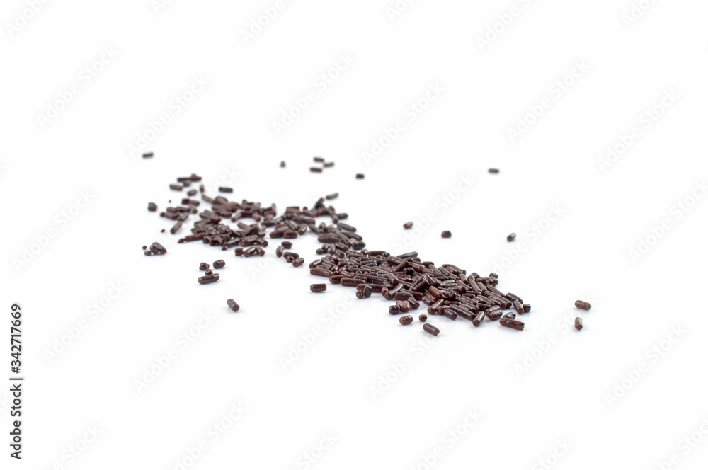 A pile of chocolate sprinkles in random order isolated against a white background. A pile of chocolate sprinkles in random order isolated against a white background.