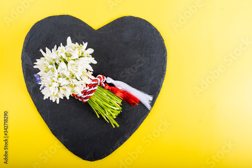 Spring time flowers like snowdrops, hyacinth and roses, isolated on yellow simple background, spring symbol and traditional romanian 