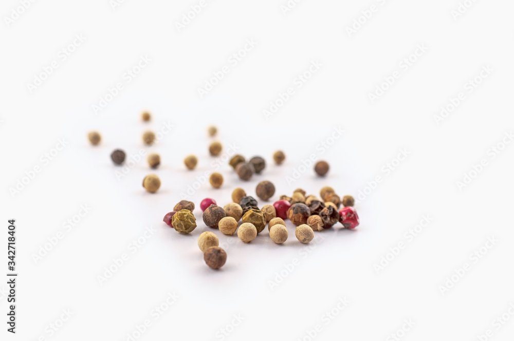 Red, green and black peppercorns or balls mixed isolated on a white background. Red, green and black peppercorns or balls mixed isolated on a white background.