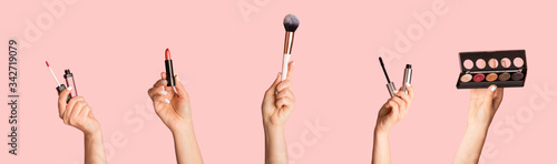 Collection of different makeup products in female hands, collage on pink background