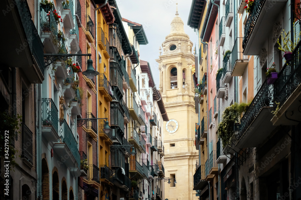 One of the towers of Pamplona Cathedral can be seen from Curia Street with its colourful facades, Navarra, Spain