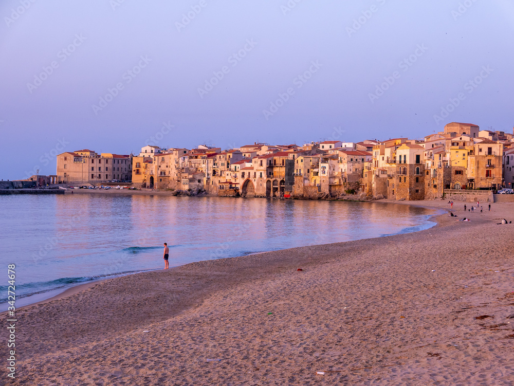 Cefalu, Messina, Sicily - Houses in front of the sea at sunset. 