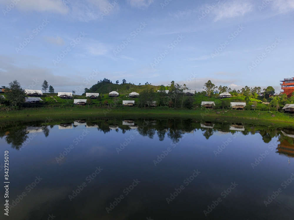 Aerial sunrise lake, Beautiful Lake Patenggang with green tea field in ciwidey Indonesia 
