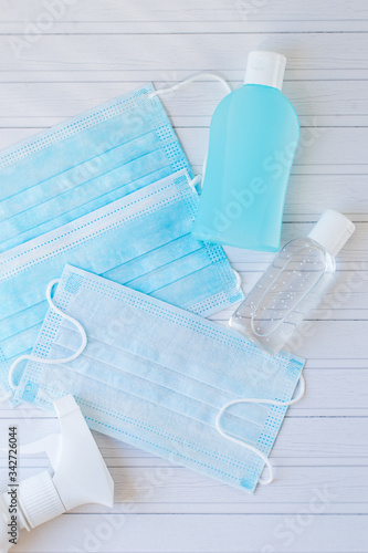 Blue and white medical mask, gel antiseptic for hand, antibacterial sanitizer. Protect against the coronavirus. Medical equipment.