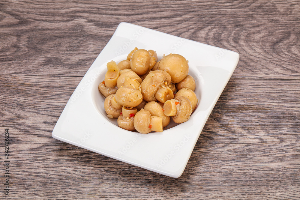 Pickled champignons in the bowl Pickled champignons in the bowl