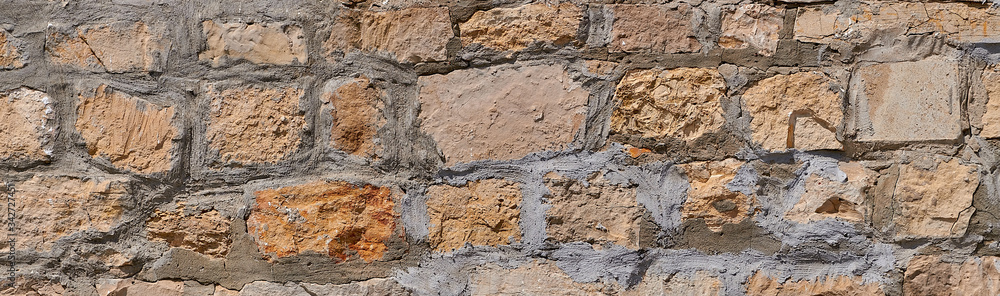 Fototapeta premium Fragment of an old masonry. Natural stone limestone.