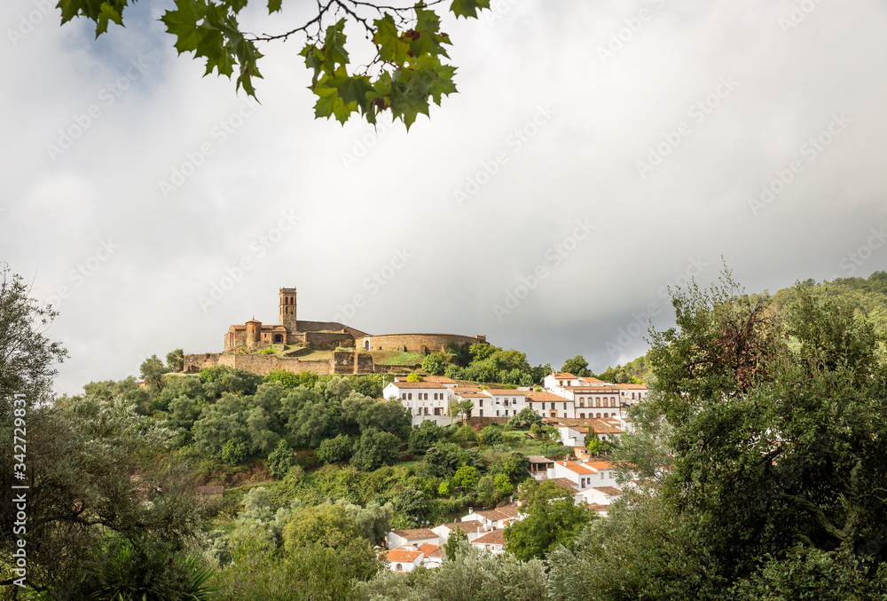 a view of Almonaster la Real town and the hilltop mosque on a cloudy day, province of Huelva, Andalusia, Spain