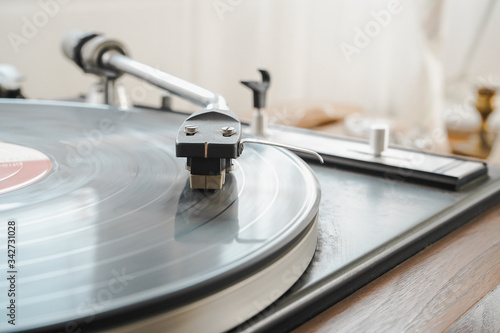 Close up vintage music record player with a black vinyl record. Music and vintage concept