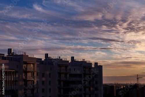 Urban industrial landscape in the evening at sunset. Beautiful blue sky, creative business buildings and residential buildings. Panoramic image from a height © Alex Vog