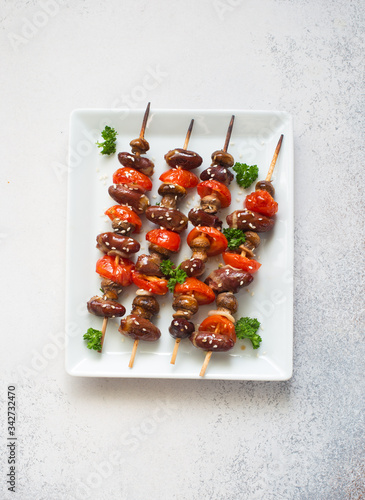 Chicken hearts, tomatoes and mushrooms skewers