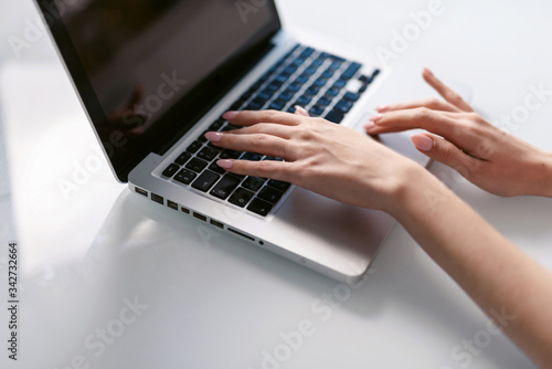 Young business woman is typing on laptop keyboard. Coronavirus. Quarantine. isolation, social distancing, freelance work from home office, self-isolation.