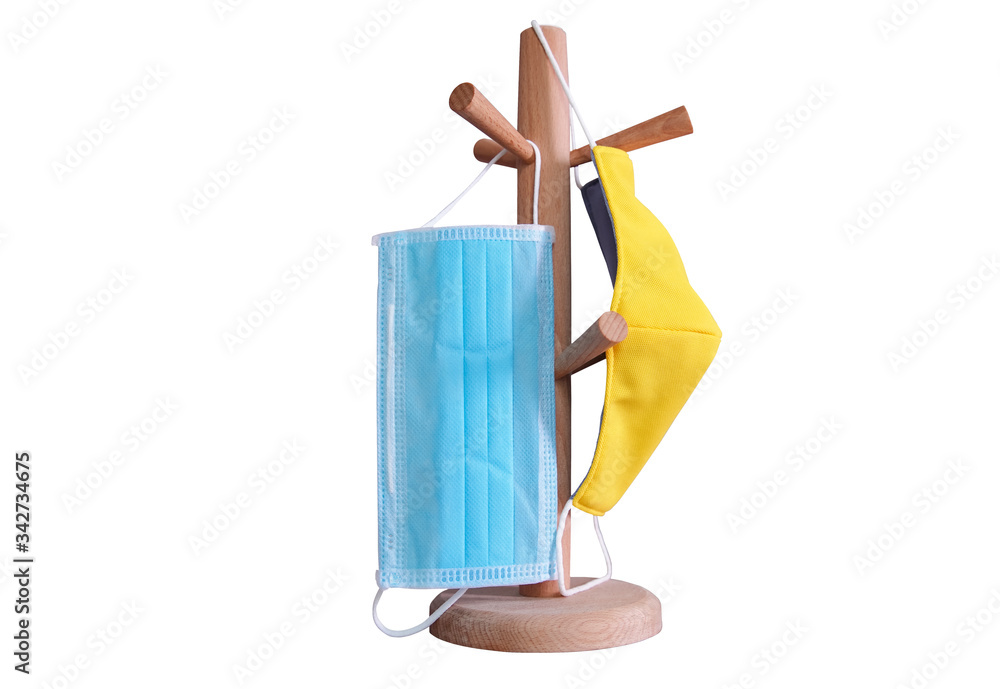 Medical mask face hanging on a wooden rack on white background Medical mask face hanging on a wooden rack on white background