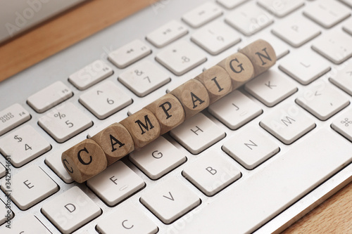 Campaign word on cube wood with keyboard background