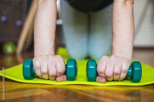 A young woman prepares to exercise at home
