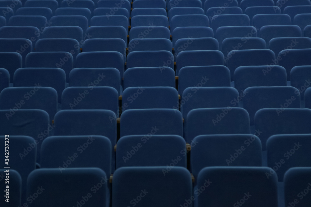 Naklejka premium Blue empty seats in the hall are prepared for participants of mass events. Organization and holding of mass events, conferences or presentations