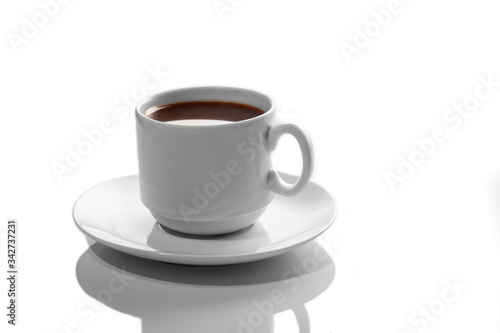 small white porcelain Cup with hot coffee on a white saucer side view isolated on a white background