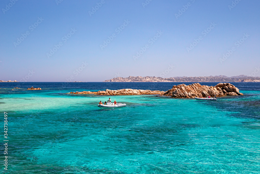 Obraz premium Panoramic view of the pink granite rock formations and the clear and transparent waters in the Maddalena archipelago in Sardinia, Italy.