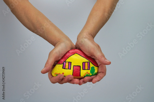 Wallpaper Mural painted stone as home in two female hands Torontodigital.ca
