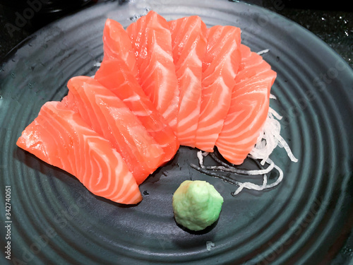 Salmon raw sashimi and wasabi on black plate,Japanese food