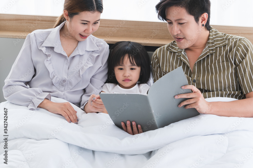 Parents and children are reading books together at home Parents and children are reading books together at home