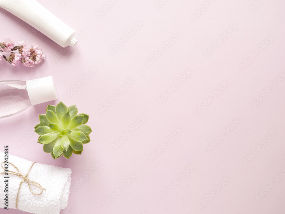 care products lotion, cream, plant, towel. bath accessories on pink background, top view, copyspace. Bodycare beauty treatments at home concept, organic products, morning routine care products lotion, cream, plant, towel. bath accessories on pink background, top view, copyspace. Bodycare beauty treatments at home concept, organic products, morning routine