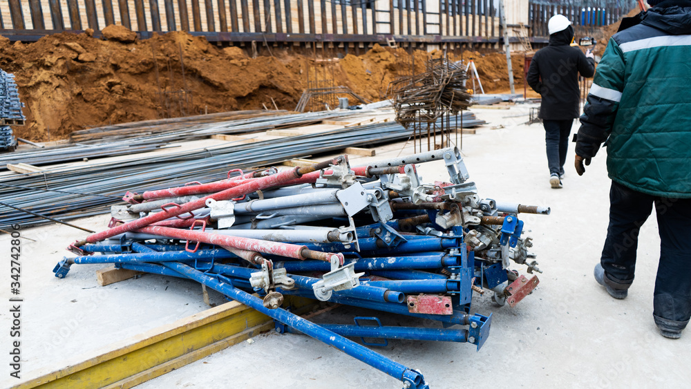 Construction, fittings, excavator, workers in suits, fastening fittings, hydraulic press