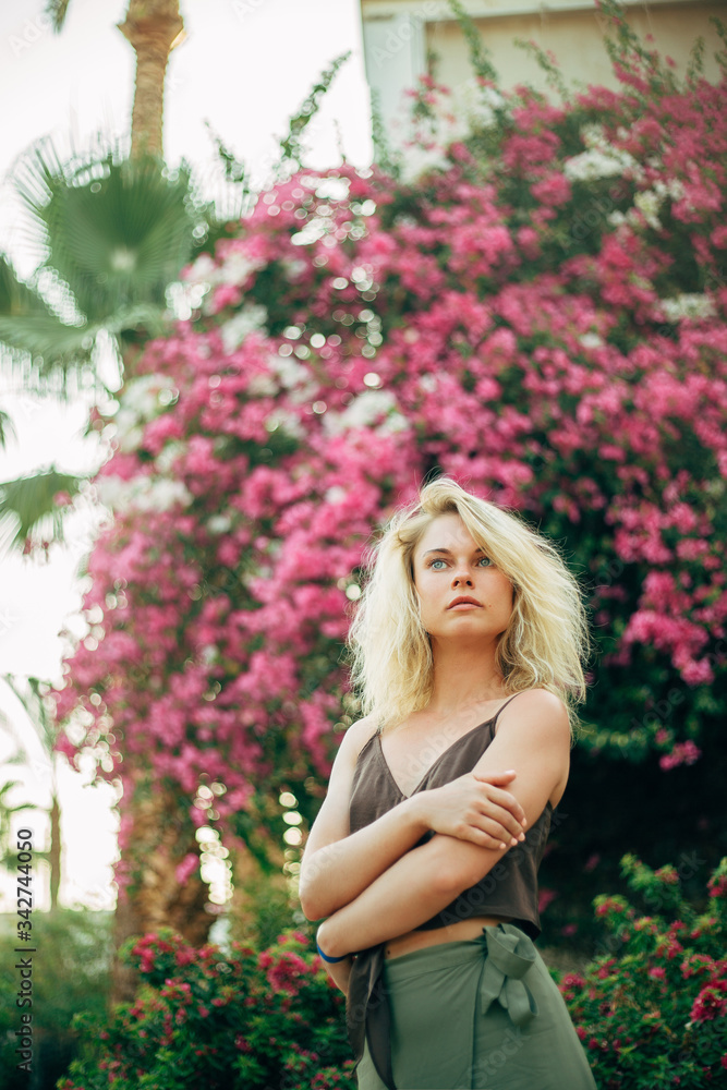 Young pretty fashion sport woman posing outdoor in summer on tropic island in hot weather. Young pretty fashion sport woman posing outdoor in summer on tropic island in hot weather.
