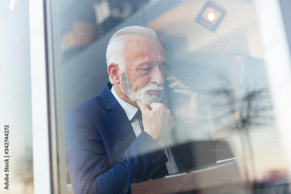 Fototapeta premium Senior businessman having a phone call