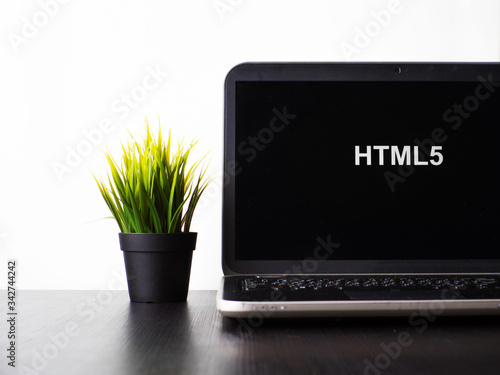 HTML5 programming language. Programming training, the concept of computer courses. Laptop on the table