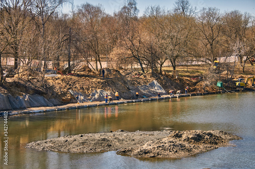 Cleaning of the river by workers and reconstruction of the park area