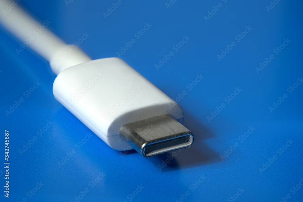 Fototapeta premium White wire usb-c on a blue background