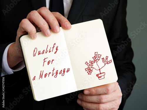 Qualify For A Mortgage phrase on the piece of paper.