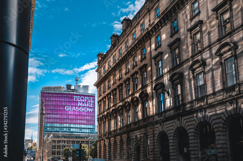A view of a Glasgow street in front of a tall building photo