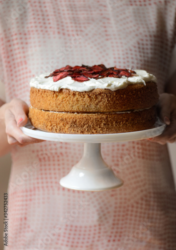 cake with strawberry and woman hand