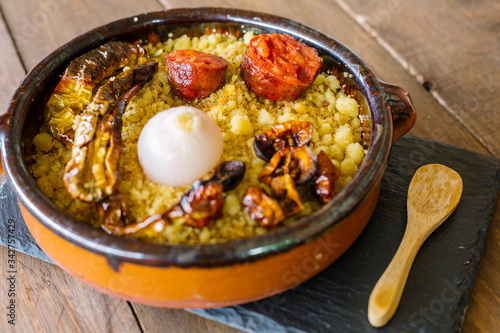 Traditional spanish gastronomy: migas with onion, chorizo and dried peppers