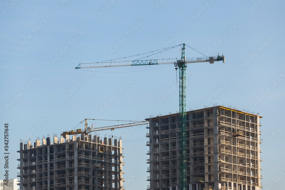 construction site with cranes against the blue sky	