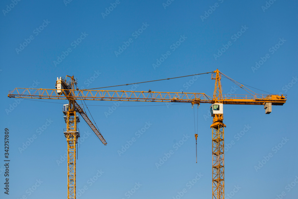 tower cranes on a background of blue sky
tower cranes on a background of blue sky
