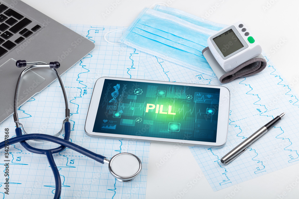 Tablet pc and medical stuff with PILL inscription, prevention concept