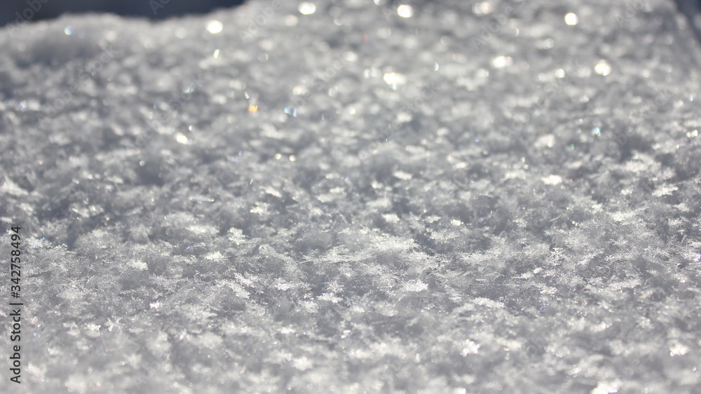 Fluffy sparkling snow. Snowflakes sparkling in the sun. Snow in the winter. Snow carpet. Snow background