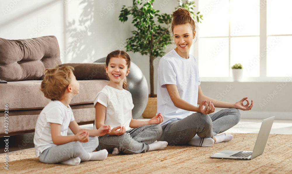Smiling woman with children meditating on floor at home. Smiling woman with children meditating on floor at home.