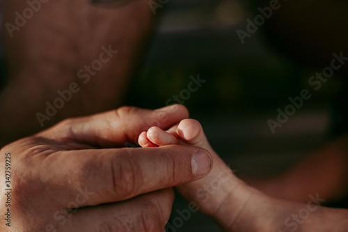 Father holding a baby toe © Evgeniya