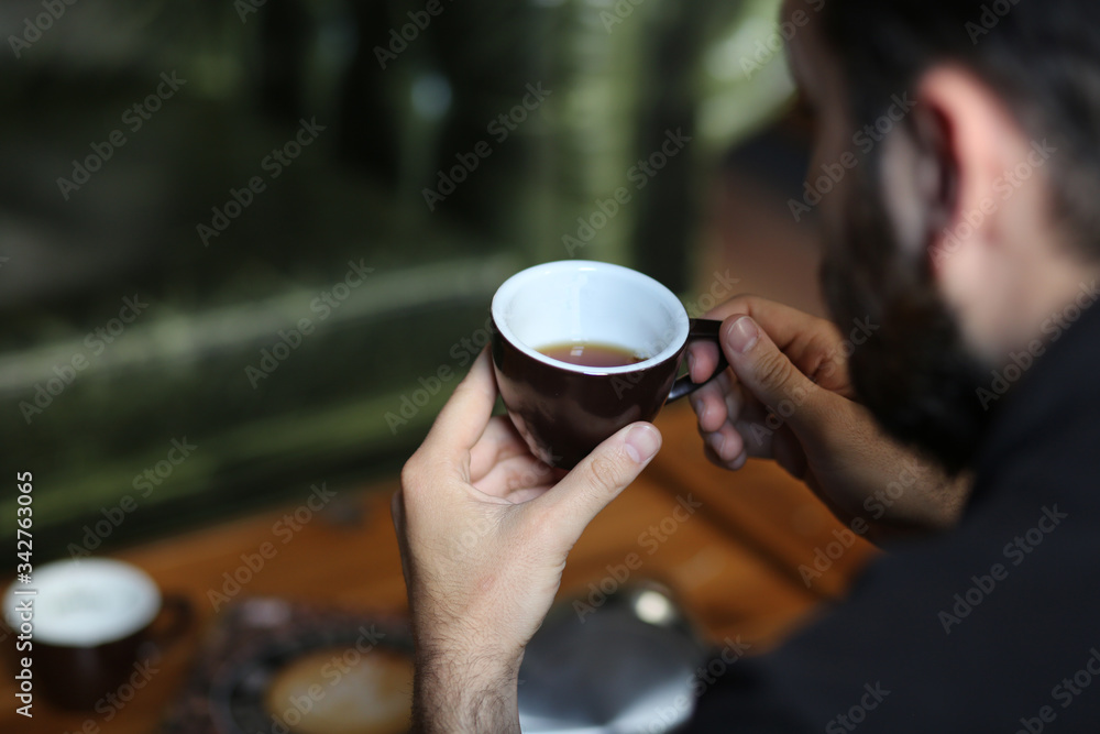 young man drinking coffee in cafe young man drinking coffee in cafe