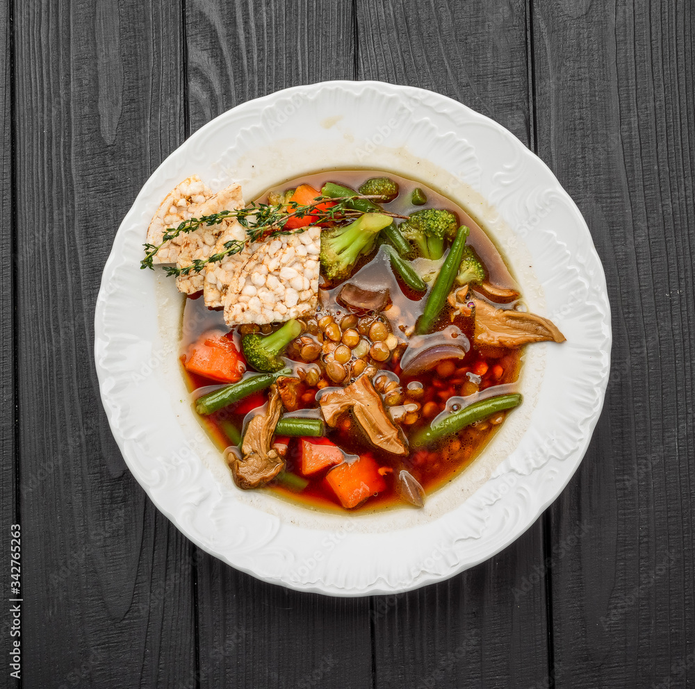 Lentil soup with porcini mushrooms on a dark background Lentil soup with porcini mushrooms on a dark background
