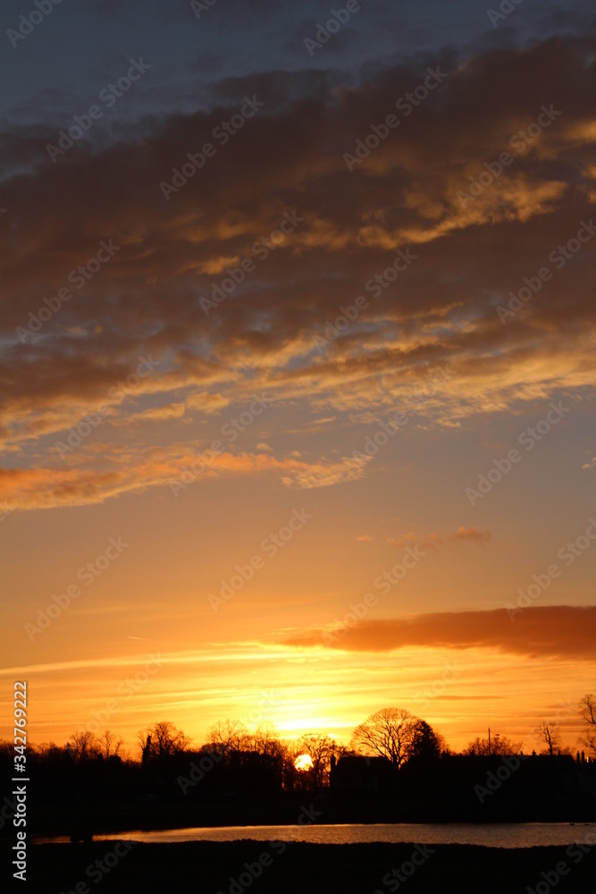 Beautiful and vibrant sunset, with the colours changing from a pink/orange colour into a clear blue sky