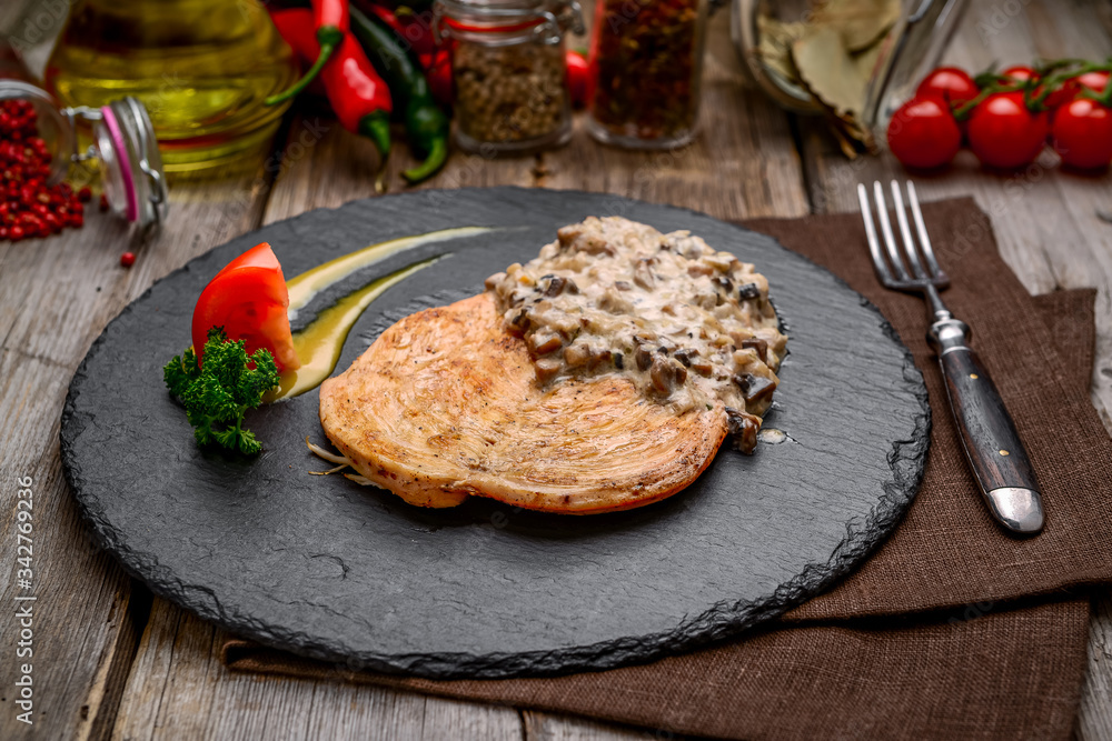 Creamy Garlic Mushroom Chicken. On a wooden table Creamy Garlic Mushroom Chicken. On a wooden table